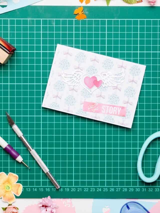 cutting mat with crafted card and tools on it